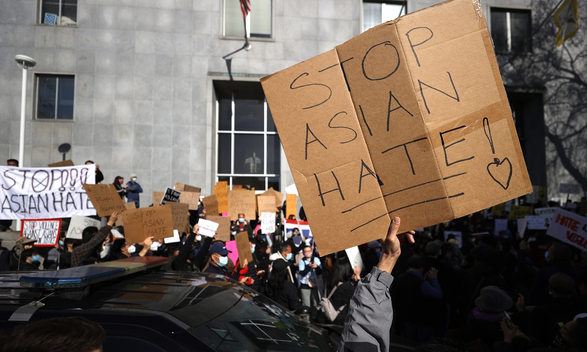 Protesters hold signs during a rally in solidarity with Asian hate crime victims on March 22 in San Francisco, California. Photo: VCG