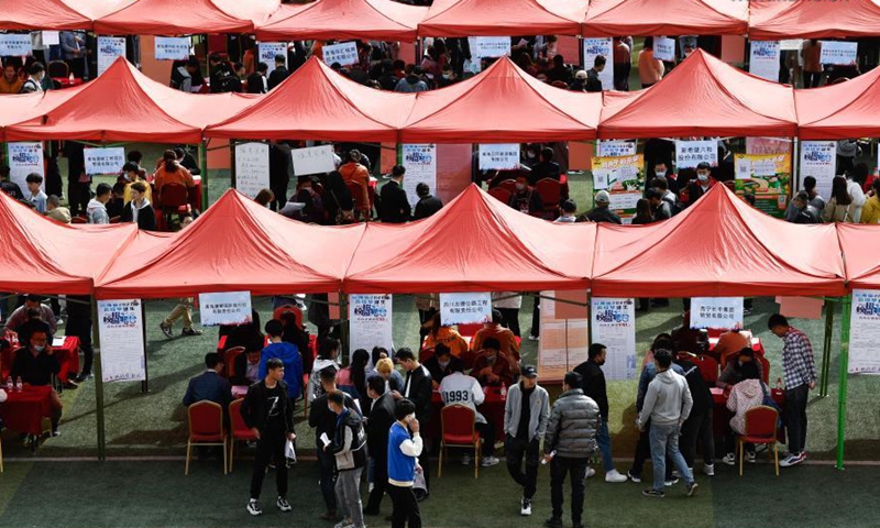 Students look for job during a spring campus job fair in Xining, capital of northwest China's Qinghai Province, March 24, 2021. A spring campus job fair for graduates of 2021 was held here on Wednesday, during which 8,500 jobs are offered by 230 plus employers. (Xinhua)
