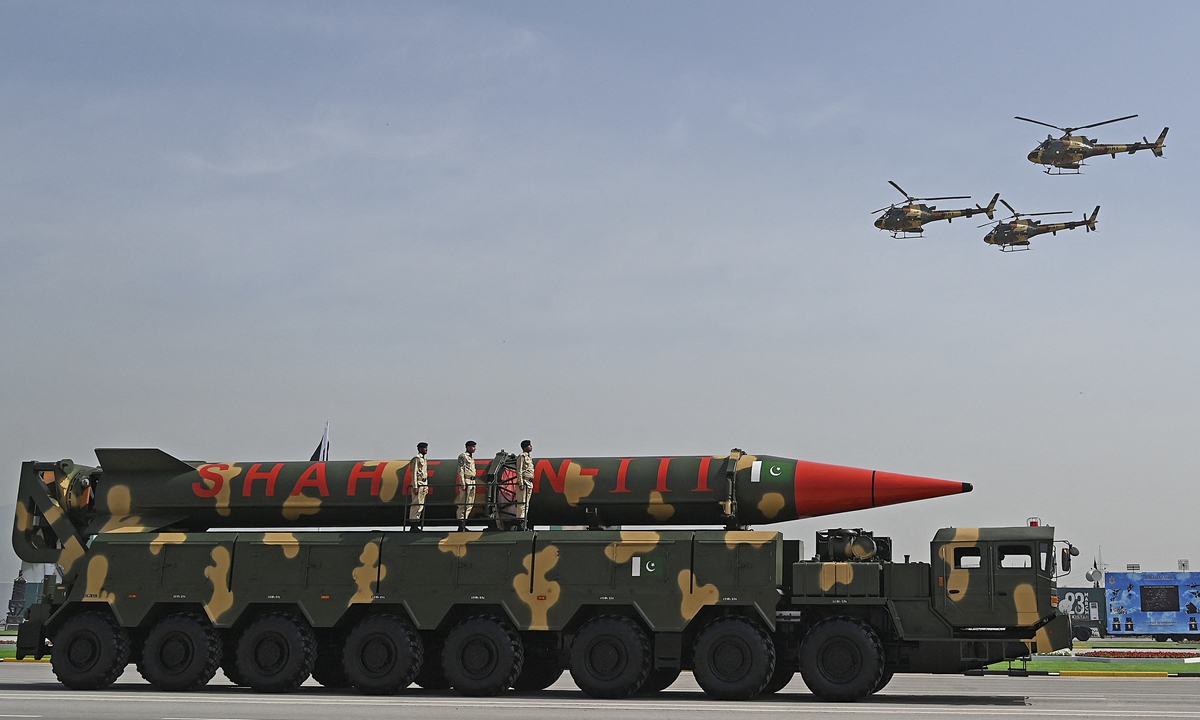 Pakistani military helicopters flying past a vehicle carrying a long-range ballistic Shaheen III missile take part in a military parade to mark Pakistan's National Day in Islamabad on Thursday. Pakistani President Arif Alvi joined senior government and military officials at the grand parade.&nbsp;Photo: AFP