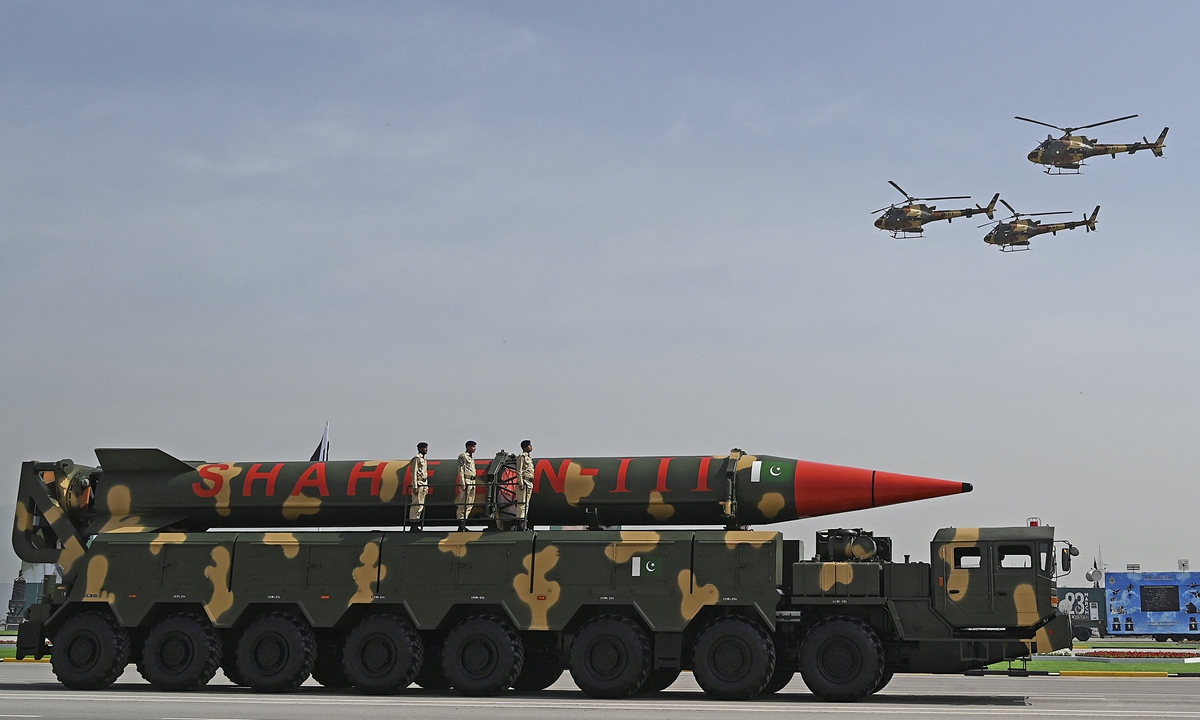 Pakistani military helicopters flying past a vehicle carrying a long-range ballistic Shaheen III missile take part in a military parade to mark Pakistan's National Day in Islamabad on Thursday. Pakistani President Arif Alvi joined senior government and military officials at the grand parade. Photo: AFP