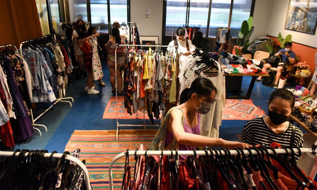 Shoppers browsing through secondhand clothes at a pop-up swap event in Singapore on January 16. Photo: AFP
