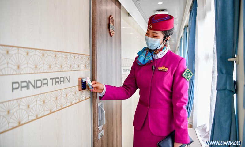 Chief conductor demonstrates a smart room lock on the panda train in southwest China's Sichuan Province, March 24, 2021. China's first panda-themed tourist train panda train started trial run in Sichuan on Wednesday and will start operation on March 28. Transformed from a normal train, the panda train features upgraded standards inclucing 5G wireless network coverage, music and video entertainment system, restaurant and bar, chess and card room and private toilets with constant temperature shower in sleeping carriages.(Photo: Xinhua)