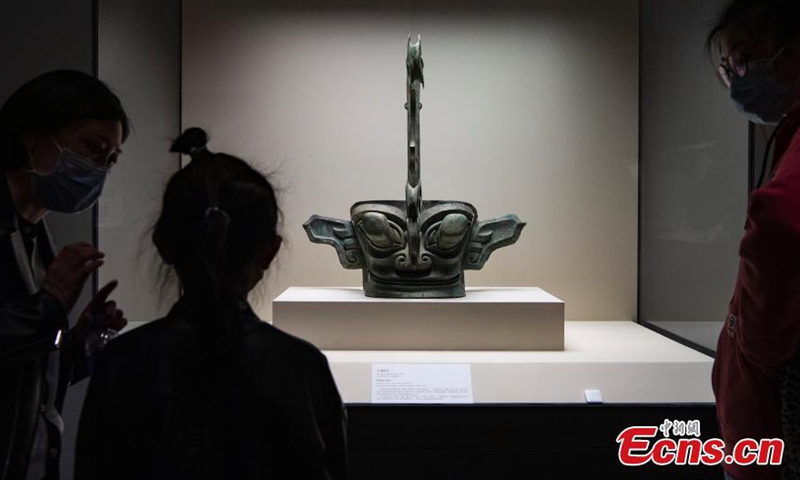Visitor looks at a bronze mask unearthed from the Sanxingdui Ruins at the National Museum of China in Beijing, March 26, 2021. The shock of hundreds of more than 3,000-year-old cultural relics newly excavated from the Sanxingdui Ruins site in SW China’s Sichuan continues across China. Some stunning discoveries from the Sanxingdui Ruins preserved at the National Museum of China has drawn a number of visitors.   Photo: China News Service