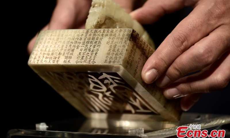 Jientang White Jade Dragon Seal for Emperor Qianlong in Qing Dynasty is presented by a staff member of Sotheby’s Hong Kong office, March 25, 2021.  Photo: China News Service