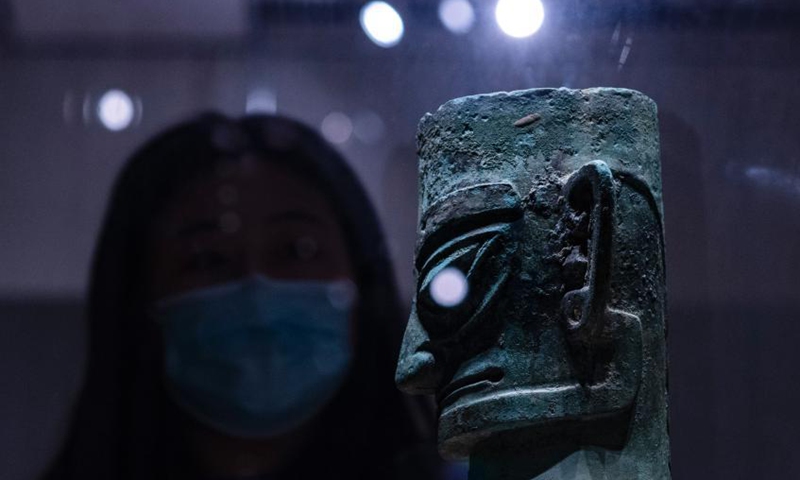 A visitor appreciates an ancient bronze figure statue unearthed from the Sanxingdui Ruins, at the National Museum of China in Beijing, March 26, 2021. The shock of hundreds of more than 3,000-year-old cultural relics newly excavated from the Sanxingdui Ruins site in SW China’s Sichuan continues across China. Some stunning discoveries from the Sanxingdui Ruins preserved at the National Museum of China has drawn a number of visitors. Photo: China News Service