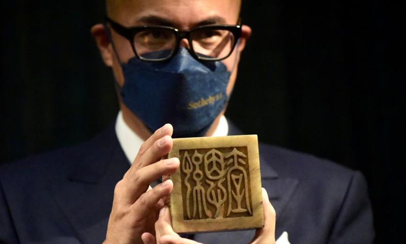 Jientang White Jade Dragon Seal for Emperor Qianlong in Qing Dynasty is presented by a staff member of Sotheby’s Hong Kong office, March 25, 2021. Photo: China News Service