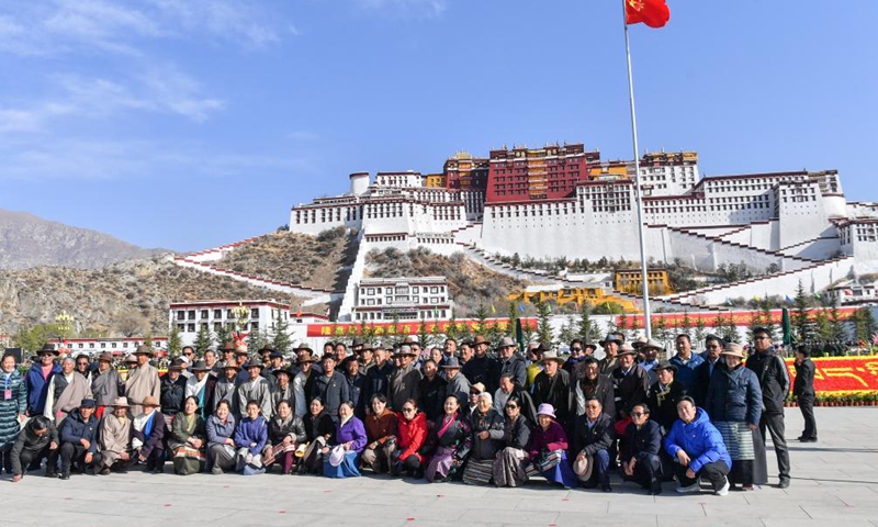 People pose for a group photo to celebrate the Serfs' Emancipation Day at the square in front of the Potala Palace in Lhasa, capital of southwest China's Tibet Autonomous Region, March 28, 2021. (Xinhua)