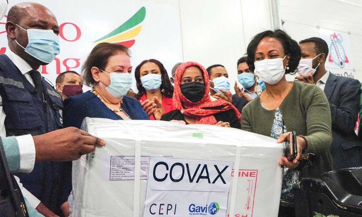 Ethiopia's Health Minister Lia Tadesse (R) receives a box of Covid-19 vaccines delivered as a part of the UN-led Covax initiative at Addis Ababa international airport, Ethiopia, on March 7.