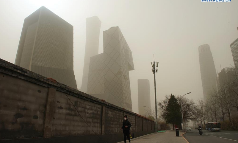 A man walks on a road in Beijing, capital of China, March 28, 2021. (Xinhua)