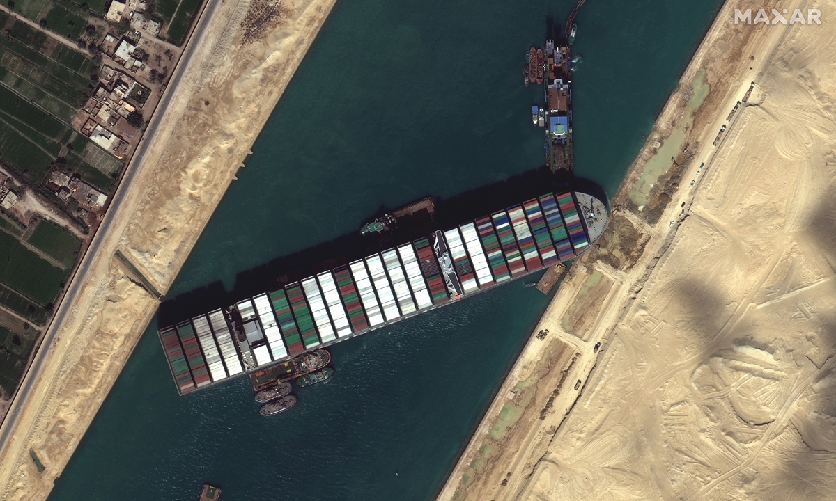 This satellite image from Maxar Technologies shows the cargo ship MV <em>Ever Given</em> stuck in the Suez Canal near Suez, Egypt, on Saturday. Photo: VCG