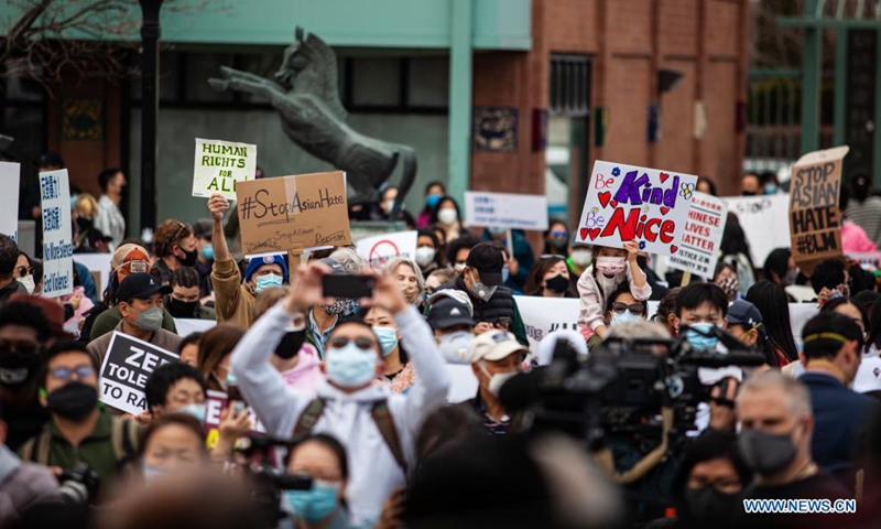 People holding signs take part in a Stop Asian Hate rally in Chinatown of Chicago, the United States, on March 27, 2021.  (Photo :Xinhua)