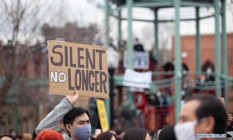 People holding signs take part in a Stop Asian Hate rally in Chinatown of Chicago, the United States, on March 27, 2021.  (Photo :Xinhua)