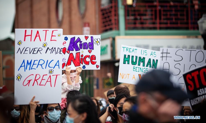 People holding signs take part in a Stop Asian Hate rally in Chinatown of Chicago, the United States, on March 27, 2021.   (Photo :Xinhua)