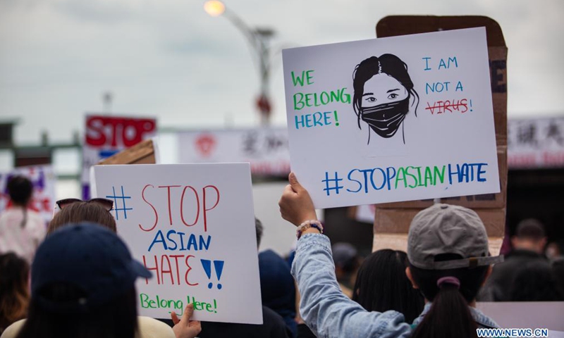 People holding signs take part in a Stop Asian Hate rally in Chinatown of Chicago, the United States, on March 27, 2021. (Photo :Xinhua)