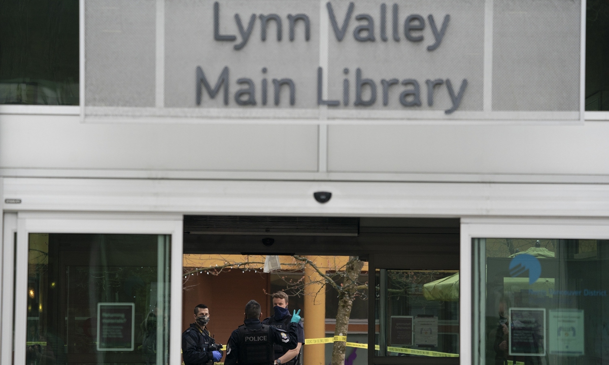 Members of the RCMP are seen outside of the Lynn Valley Library, in North Vancouver, British Columbia, Saturday, March 27, 2021. Photo: VCG