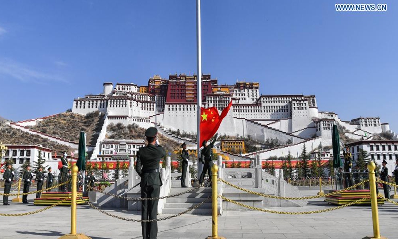 A flag-raising ceremony is held to celebrate the Serfs' Emancipation Day at the square in front of the Potala Palace in Lhasa, capital of southwest China's Tibet Autonomous Region, March 28, 2021. (Xinhua/Jigme Dorge)