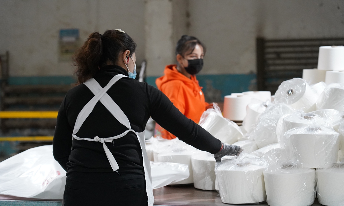 Workers work at a processing workshop of Taichang Cotton Industry Development Company in Bayingolin Mongolian Autonomous Prefecture, Xinjiang in December 2020. Photo: Yang Ruoyu/GT