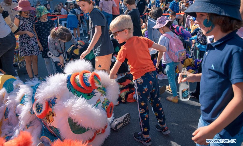 Children play during the outdoor arts and music festival CubaDupa in Wellington, New Zealand, March 27, 2021. The Cuba Street Precinct in New Zealand's capital here has come alive over the weekend as Chinese lion dances and traditional Chinese music adorned New Zealand's largest outdoor arts and music festival CubaDupa.(Photo: Xinhua)