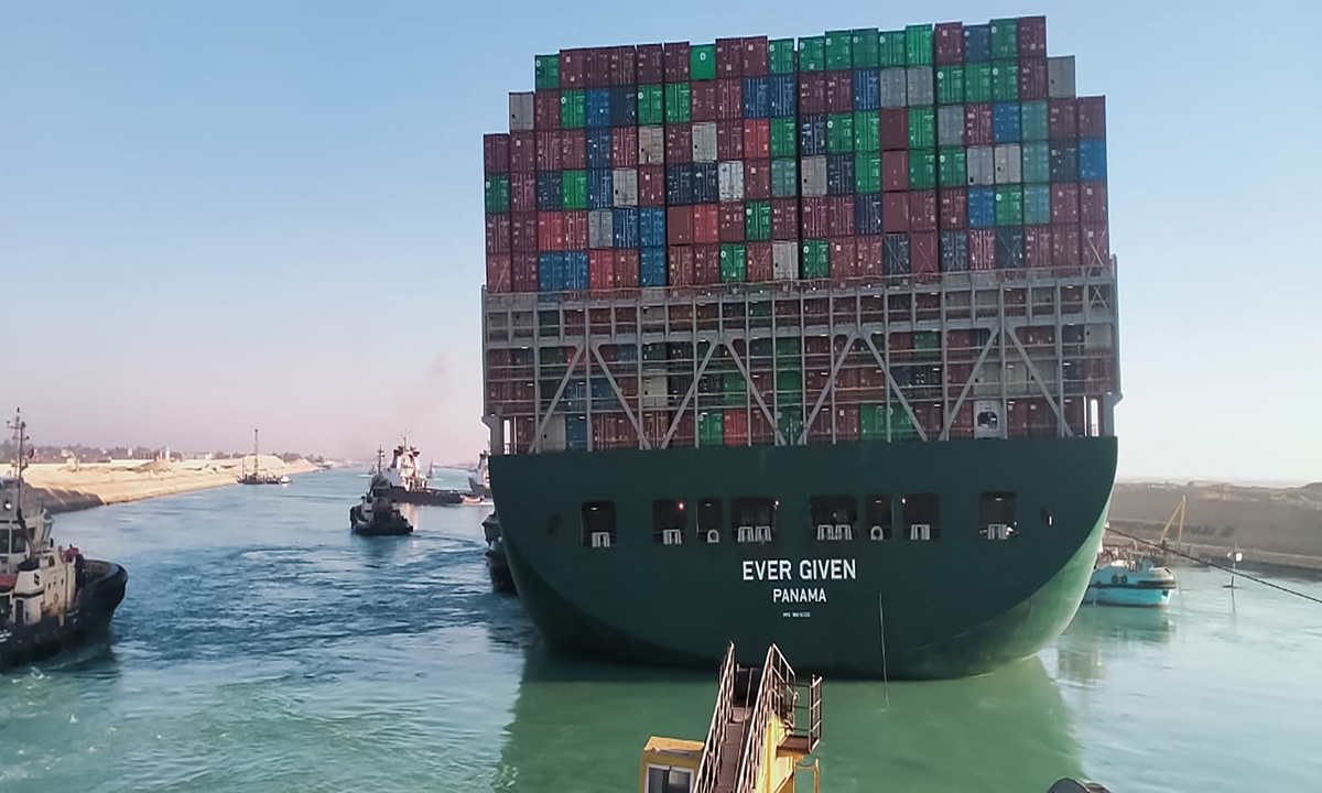 This picture taken on Monday from a nearby tugboat in the Suez Canal shows a view of the Ever Given, a Panama-flagged cargo ship, as it begins to move. Egypt's Suez Canal Authority said on Monday the Ever Given container ship, which has been blocking the crucial waterway for nearly a week, has been turned in the 
