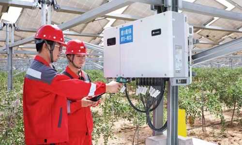 Engineers check a Huawei smart inverter. Photos: Courtesy of Huawei