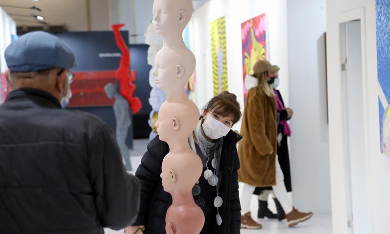 People wearing face masks visit an international contemporary art fair in Ankara, Turkey, on March 30, 2021.  Photo: Xinhua