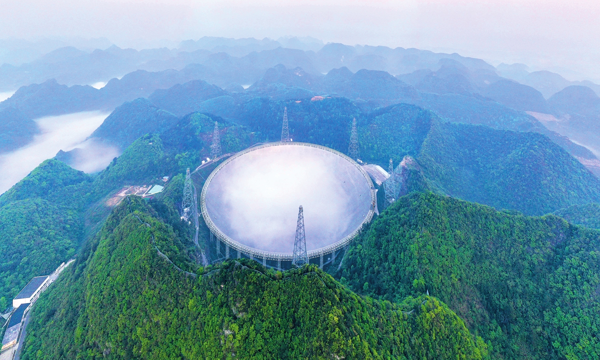The 500-meter aperture spherical radio telescope (FAST) sits in the middle of mountains  Photo: Xinhua 