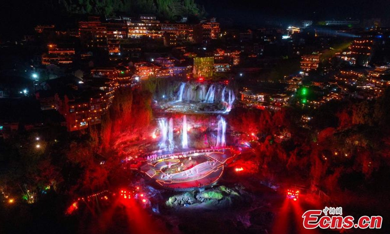 Photo taken on March 31, 2021 shows the cliff and waterfall stage in Furong Town, central China's Hunan Province. A Guochao show, the resurgence of traditional style and cultural elements, debuted in Furong Town on Wednesday night. Inheritors of the intangible cultural heritage perform with young singers and dancers, combining traditional intangible culture with modern arts, in the hope to appeal more young people to traditional Chinese culture. Photo: China News Service