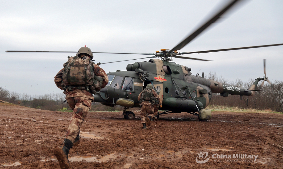 Soldiers assigned to an army aviation brigade under the PLA 72nd Group Army queue to board a transport helicopter quickly during a fast-roping training exercise which aims to beef up the troops' coordinated operational capability on March 20, 2021. Photo: China Military Online