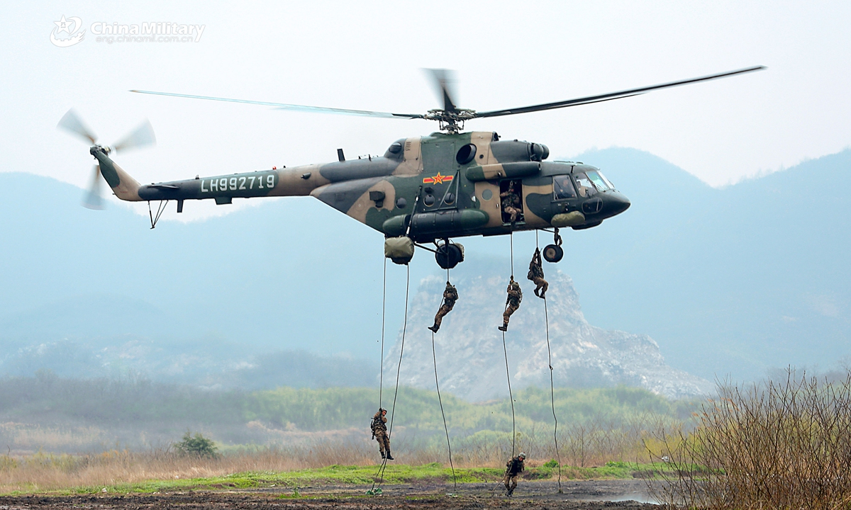 Soldiers assigned to an army aviation brigade under the PLA 72nd Group Army rappel from a transport helicopter during a fast-roping training exercise which aims to beef up the troops' coordinated operational capability on March 20, 2021.   Photo: China Military Online