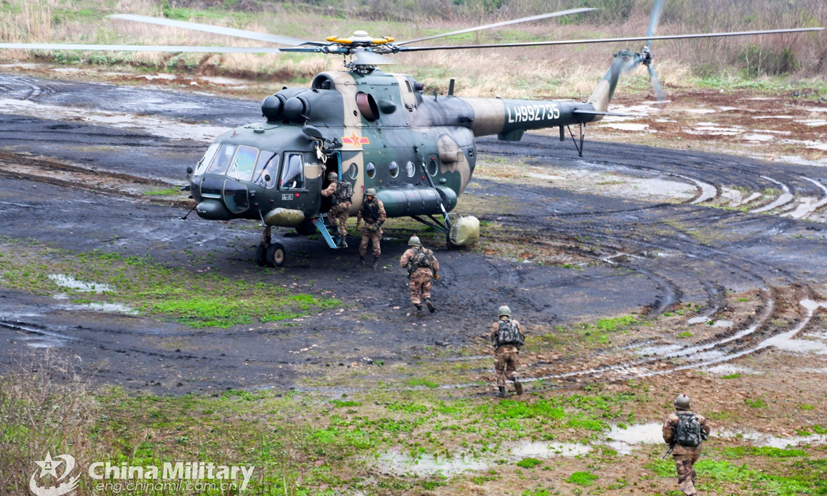 Soldiers assigned to an army aviation brigade under the PLA 72nd Group Army queue to board a transport helicopter quickly during a fast-roping training exercise which aims to beef up the troops' coordinated operational capability on March 20, 2021.  Photo: China Military Online