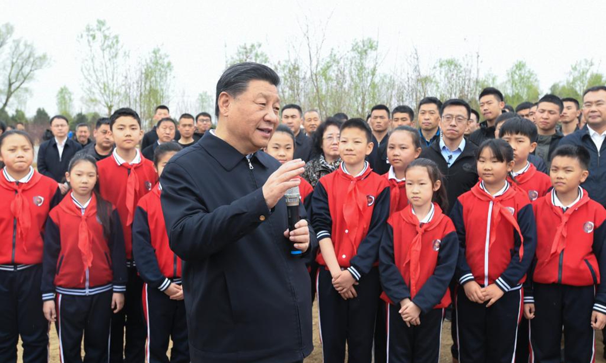 Chinese President Xi Jinping, also general secretary of the Communist Party of China Central Committee and chairman of the Central Military Commission, talks with the officials, people and school children on-site during a tree-planting activity in Chaoyang District in Beijing, capital of China, April 2, 2021. The activity was also attended by other leaders including Li Keqiang, Li Zhanshu, Wang Yang, Wang Huning, Zhao Leji, Han Zheng and Wang Qishan. (Xinhua/Li Xueren)