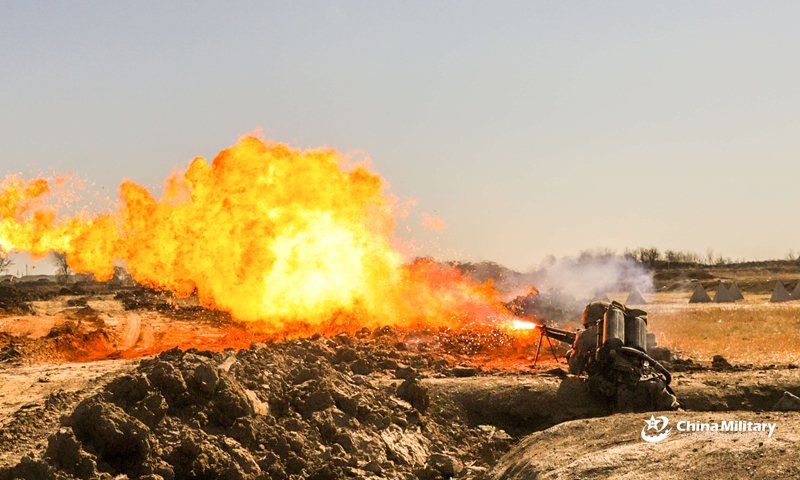 A soldier assigned to an engineering and chemical defense element of a combined arms brigade under the 81st Group Army fires a flame thrower at the mock target during the tactical training in late March, 2021.Photo:China Military