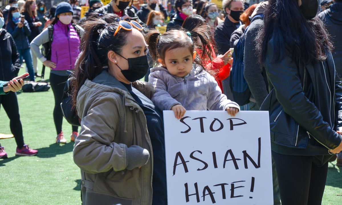 A young participant is seen holding a placard at Columbus Park in Lower Manhattan during Stop Asian Hate demonstration to show support to Asian community in New York City. Photo: VCG