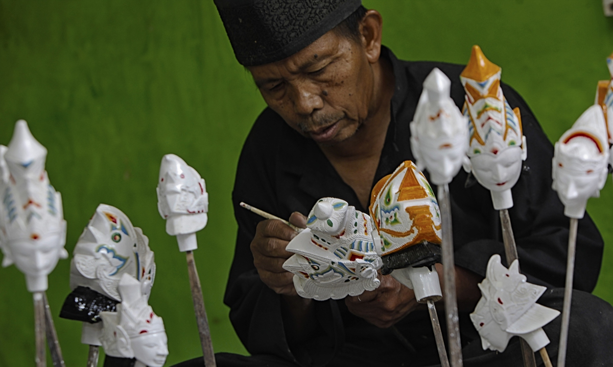 Wayang Golek craftsman Entang Sutisna (73), produces wayang golek made of lame wood (Alstonia scholaris) at Media Art, in Bogor City, West Java, Indonesia, on October 15, 2020. Photo: VCG
