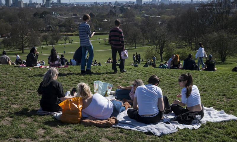 People enjoy the warm weather in London's Primrose Hill, in Britain, March 29, 2021.(Photo: Xinhua)