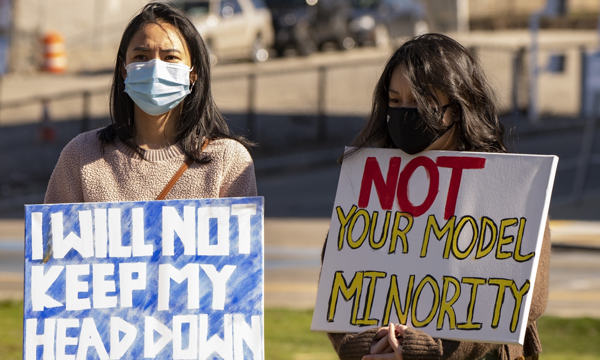 A protester holds sign during Stop Asian Hate Rally at Nubian Square in Boston, the US, on March 27. Photo: VCG