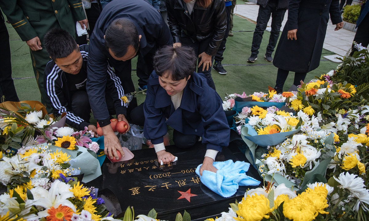 Yang Suxiang sweeps the tombstone of her son Wang Zhuoran, a martyr sacrificed in the China-India border clash in June 2020, with a towel in Luohe, Central China's Henan Province on Saturday. Photo: Li Hao/GT