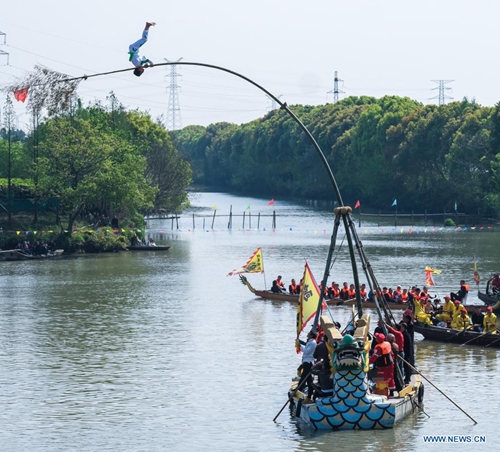 An acrobatic performance in worship of Canshen, the local patron god of silkworm raisers, is seen during a temple fair at Qinghe Village, Zhouquan Township, Tongxiang City of east China's Zhejiang Province, April 4, 2021.(Photo: Xinhua)