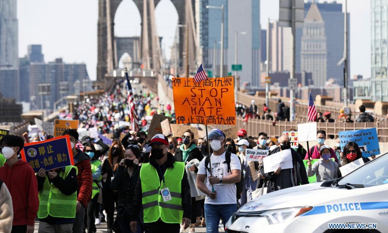 People march to protest against anti-Asian hate crimes on Brooklyn Bridge in New York, the United States, April 4, 2021. A big Stop Asian Hate rally and march was held here on Sunday.(Photo: Xinhua)
