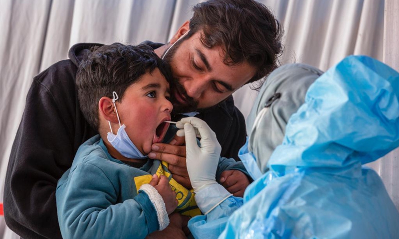 A health worker takes a swab sample from a child for COVID-19 test in Srinagar city, the summer capital of Indian-controlled Kashmir, April 5, 2021.(Photo: Xinhua)