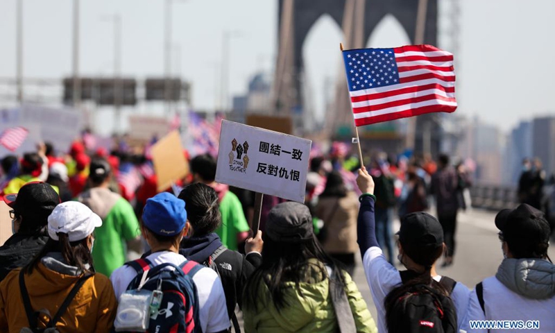 People march to protest against anti-Asian hate crimes on Brooklyn Bridge in New York, the United States, April 4, 2021. A big Stop Asian Hate rally and march was held here on Sunday.(Photo: Xinhua)