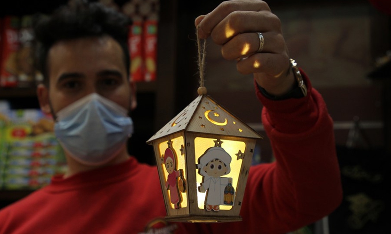 A Palestinian vendor shows a Ramadan lantern at a market ahead of the Islamic holy month of Ramadan in Gaza City, on April 4, 2021.(Photo: Xinhua)