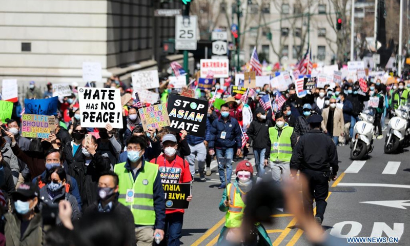 People march to protest against anti-Asian hate crimes on Brooklyn Bridge in New York, the United States, April 4, 2021. A big Stop Asian Hate rally and march was held here on Sunday.(Photo: Xinhua)