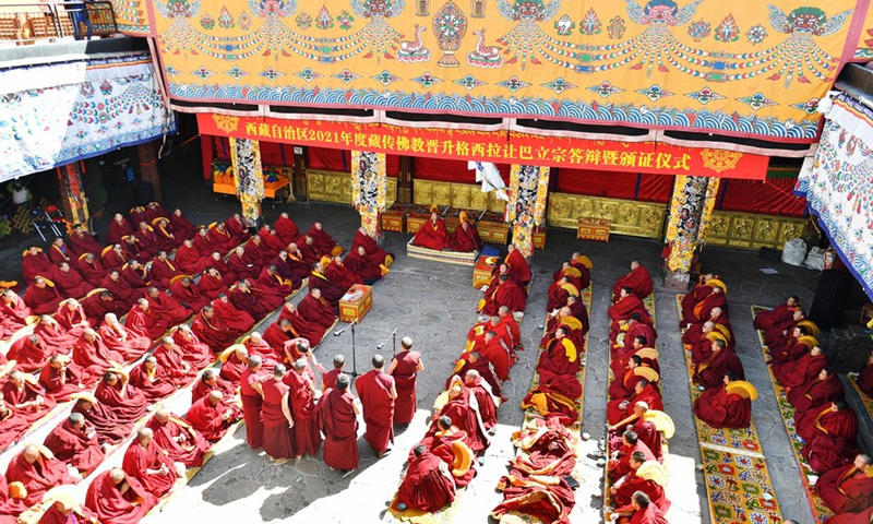 Monks attend the debate activity, a part of the award ceremony of the degree of Geshe Lharampa held in the Jokhang Temple in Lhasa, capital of southwest China's Tibet Autonomous Region, April 5, 2021.(Photo: Xinhua)