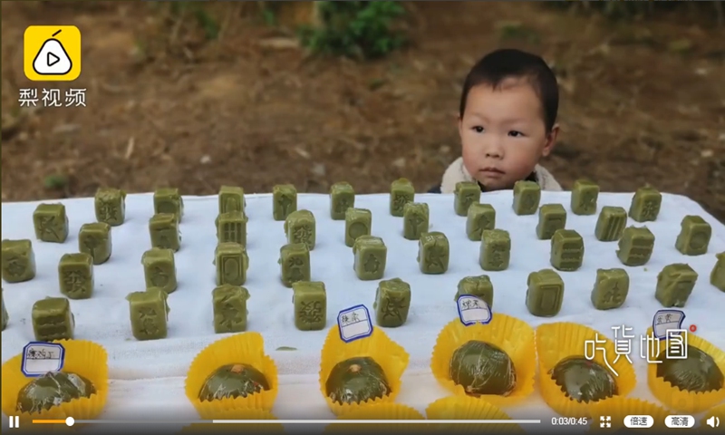 A small stall at a countryside market in Southwest China's Chongqing Municipality has outdone other scenic spots for its ingenious combination of two Chinese favorites - Qingtuan and mahjong. Photo: screenshot of Pear Video on Sina Weibo.