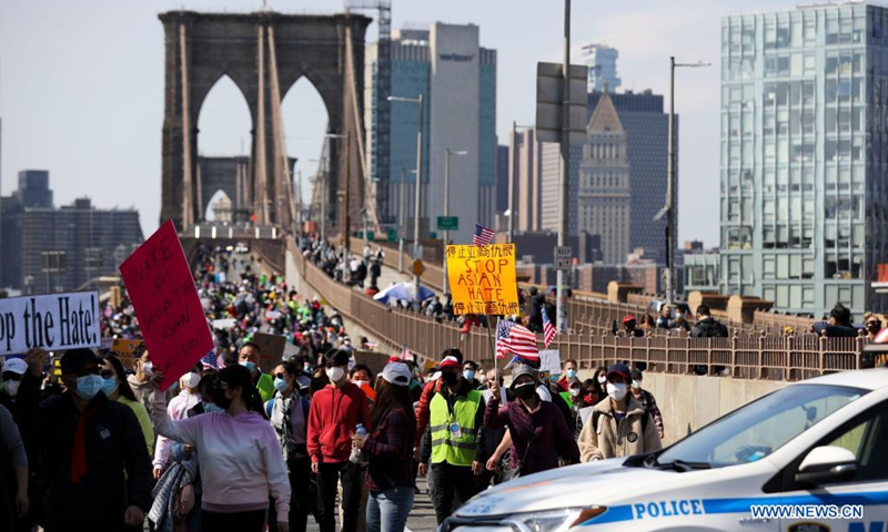 People march to protest against anti-Asian hate crimes on Brooklyn Bridge in New York, the United States, April 4, 2021. A big Stop Asian Hate rally and march was held here on Sunday.(Photo: Xinhua)