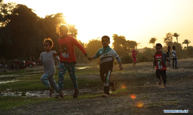 Children play near the Bent Pyramid in Giza, Egypt, April 5, 2021. The Bent Pyramid has a history of more than four thousand years, locating at Dahshur royal necropolis in Giza, south of Cairo. The pyramid was named as the Bent Pyramid or the Pyramid with Two Angles for having two different angles of inclination from base to top.(Photo: Xinhua)