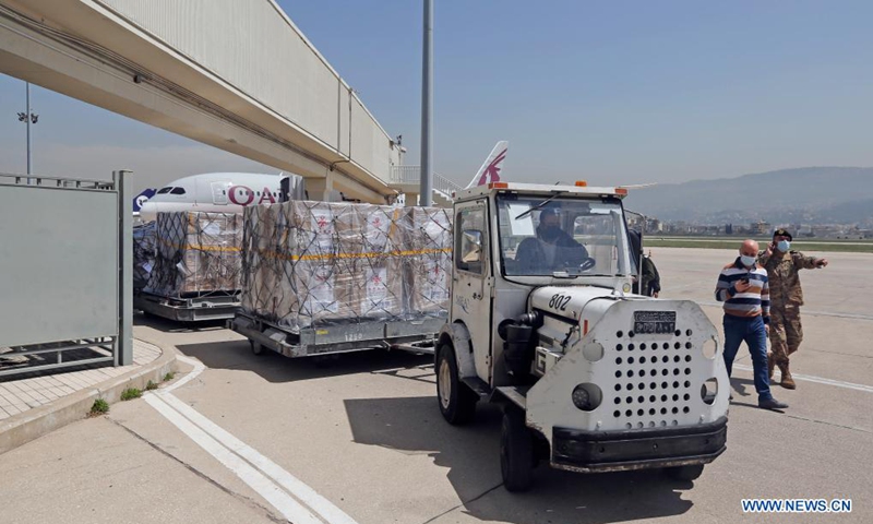 Staff transport the Sinopharm vaccines donated by China at the Rafic Hariri International Airport in Beirut, Lebanon, April 6, 2021. Two batches of Sinopharm vaccines donated by China arrived in Lebanon on Tuesday.(Photo: Xinhua)