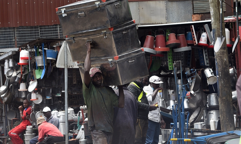 A man was transporting metal storage boxes from Kamukunji Jua Kali metal workshop in Nairobi, capital of Kenya, April 5, 2021.(Photo: Xinhua)