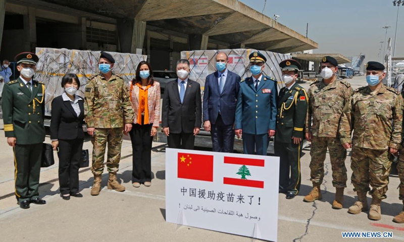 Chinese Ambassador to Lebanon Wang Kejian (5th L), Lebanese Caretaker Health Minister Hamad Hassan (6th L) pose for a group photo with others in front of the Sinopharm vaccines donated by China at the Rafic Hariri International Airport in Beirut, Lebanon, April 6, 2021. Two batches of Sinopharm vaccines donated by China arrived in Lebanon on Tuesday.(Photo: Xinhua)